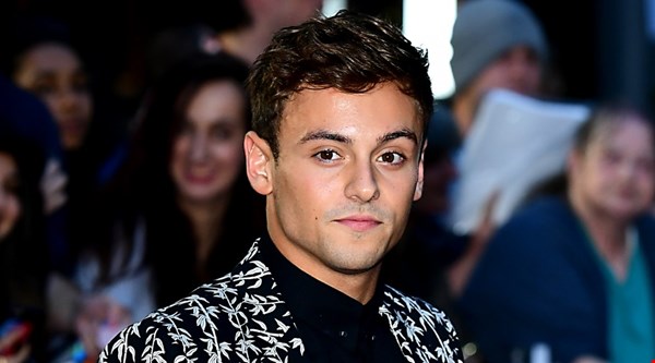 Tom Daley makes a splash on the GQ Men of the Year Awards red carpet in daringly loud suit