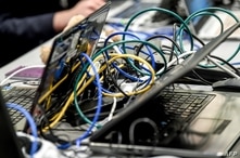 Picture of wires plugged on laptop computers taken as people work on January 22, 2019 in Lille during the 11th International…