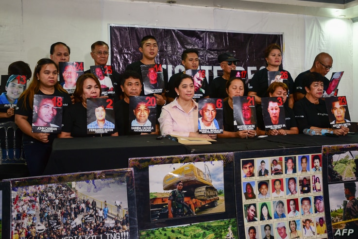 Relatives and supporters of victims of the 2009 Maguindanao massacre hold pictures of the victims during a press conference…