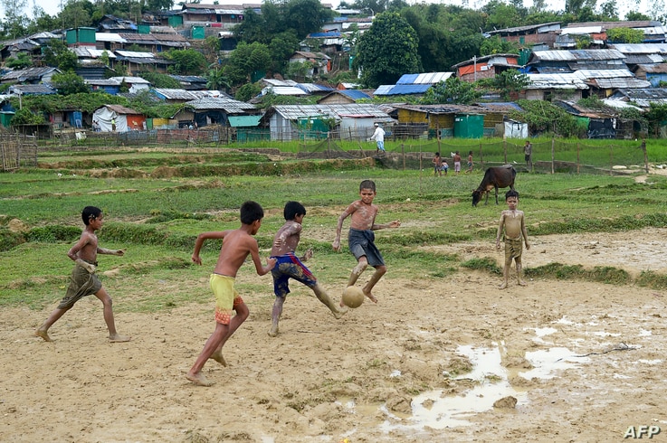 Rohingya refugee children play football at Thankhali refugee camp, in Ukhia on October 6, 2020. (Photo by Munir Uz Zaman / AFP)