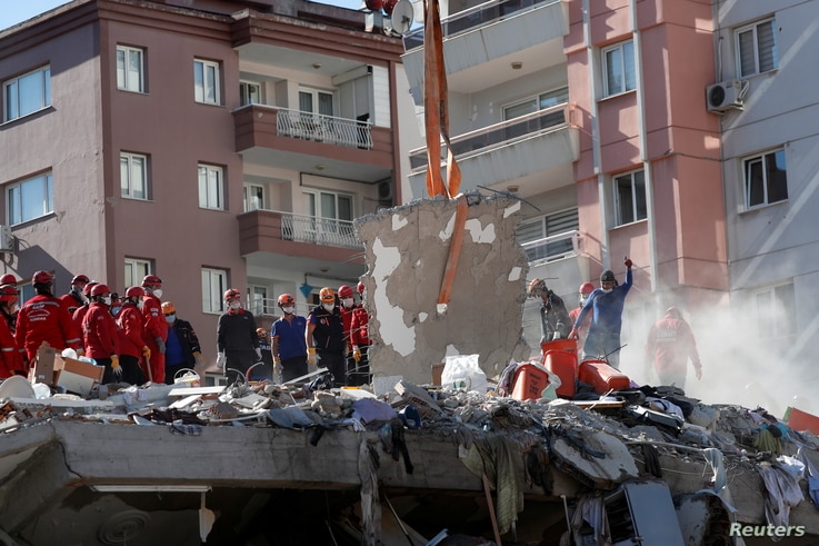 Rescue workers search for survivors at a collapsed building after an earthquake in the Aegean port city of Izmir, Turkey…