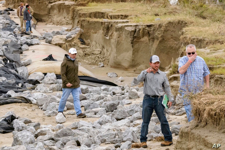 Members of the U.S. Army Corps of Engineers survey levee damage along Grand Isle, La., Friday, Oct. 30, 2020.  Gov. John Bel…