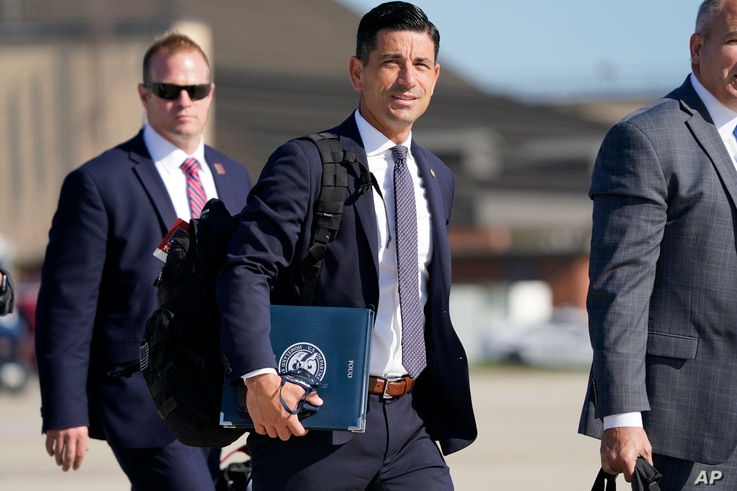 Acting-Secretary of Homeland Security Chad Wolf, center, arrives to join President Donald Trump at Andrews Air Force Base in Md., Tuesday, Aug. 18, 2020. Trump will speak at a campaign rally in Yuma, Ariz. (AP Photo/J. Scott Applewhite)