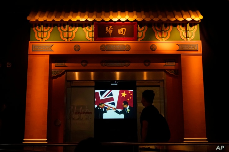 A screen shows the ceremony of British handover Hong Kong to China, at the exhibition 