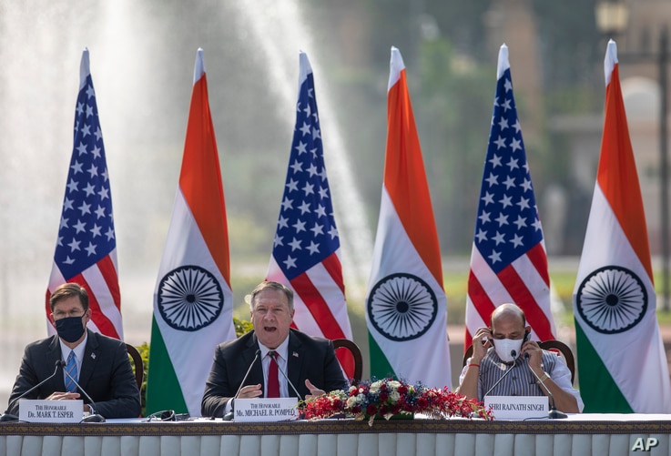 U.S. Secretary of State Mike Pompeo, center, speaks as Secretary of Defence Mark Esper, left, and Indian Defence Minister Rajnath Singh sit beside him during a joint press conference at Hyderabad House in New Delhi, India, Oct. 27, 2020.