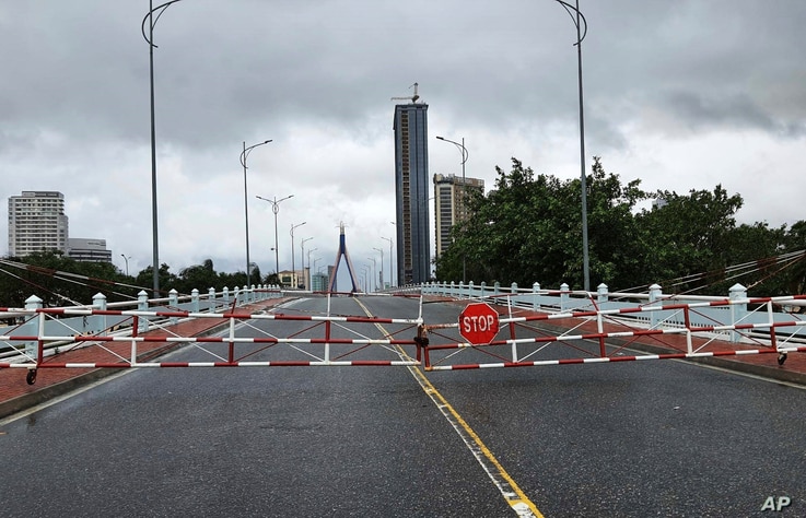 An empty street is barricaded ahead of Typhoon Molave in Da Nang, Vietnam Wednesday, Oct. 28, 2020. Typhoon Malove sank a few…