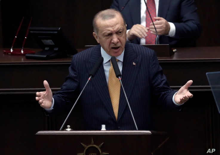 Turkey's President Recep Tayyip Erdogan addresses his ruling party lawmakers at the parliament, in Ankara, Turkey, Wednesday,…