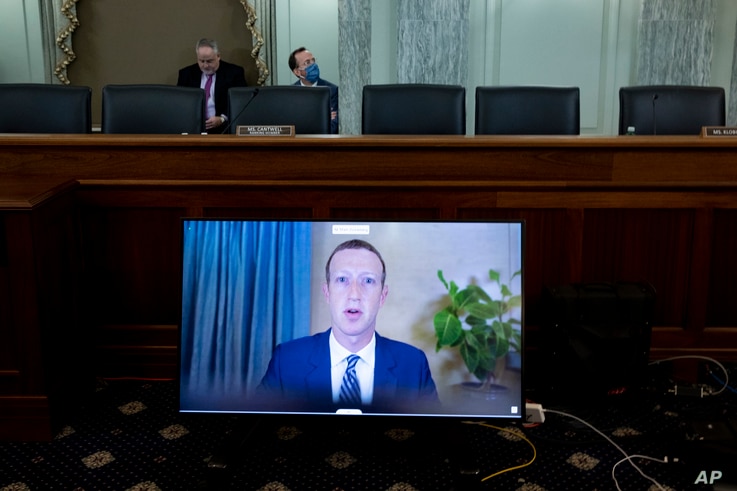 Facebook CEO Mark Zuckerberg appears on a screen as he speaks remotely during a hearing before the Senate Commerce Committee on Capitol Hill, Oct. 28, 2020, in Washington.