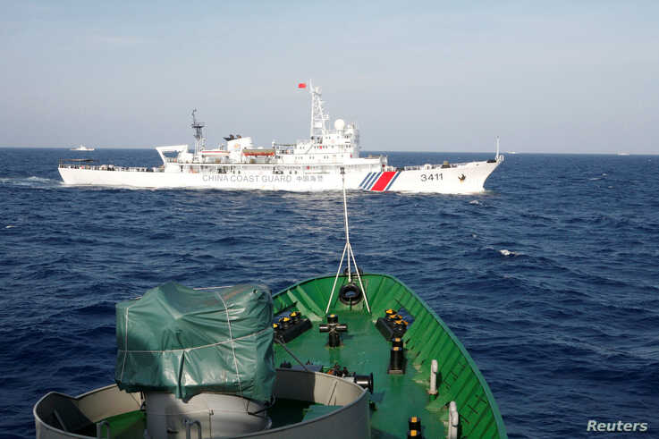 FILE PHOTO: A ship (top) of the Chinese Coast Guard is seen near a ship of the Vietnam Marine Guard in the South China Sea,…