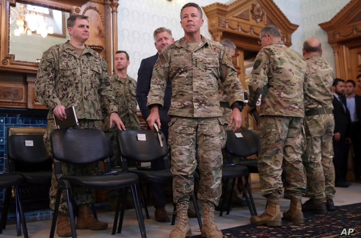 FILE - U.S. Army General Scott Miller, center, commander of U.S. and NATO troops in Afghanistan, is seen at the presidential palace in Kabul, Afghanistan, Nov. 6, 2018.