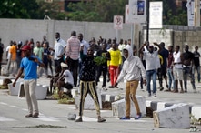 Young people protest at the Lekki toll gate in Lagos, Nigeria, Oct. 21, 2020. The Lekki toll gate was the site where demonstrators were fired upon earlier in the week in an escalation that sparked global outrage.