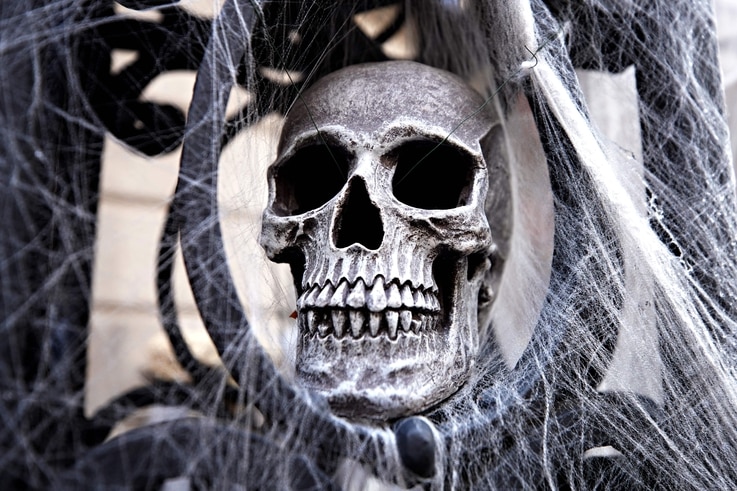 NEW YORK, NEW YORK - OCTOBER 30: A skull and spider webs are part of a Halloween display in front of an Upper East Side home on…