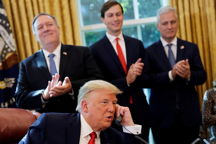 U.S. President Donald Trump is seen on the phone with leaders of Israel and Sudan  in the Oval Office at the White House in Washington