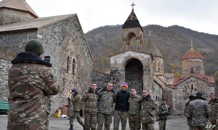 Armenian soldiers pose for a photo near the 12th-13th century Orthodox Dadivank Monastery on the outskirts of Kalbajar on…