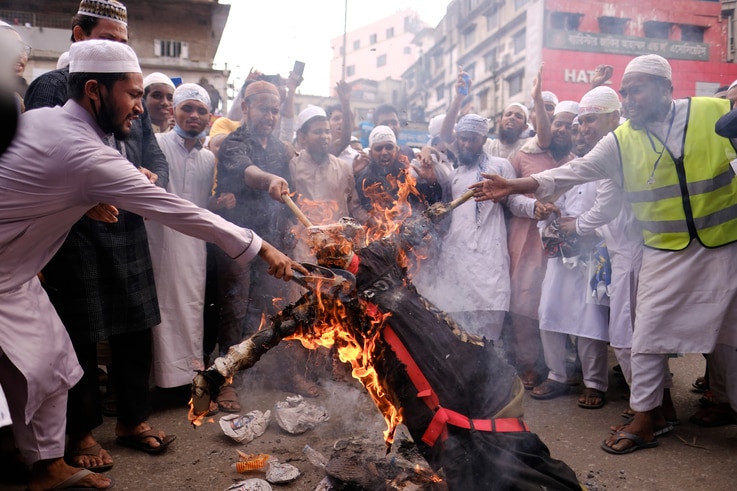 Bangladeshi Muslims protesting the French president’s support of secular laws allowing caricatures of the Prophet Muhammad…