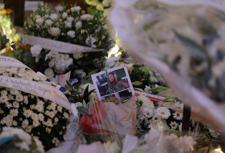 Portrait of a deadly knife attack victim is seen among flowers in front of the Notre Dame church in Nice, France, October 31,…
