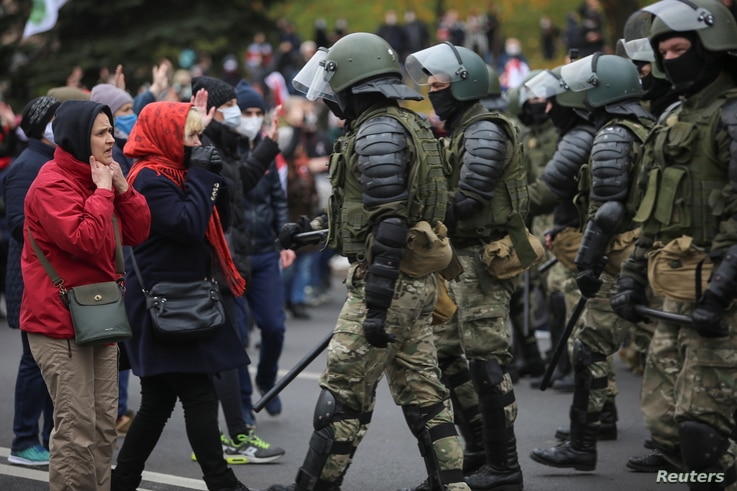 Belarusian law enforcement officers block opposition supporters during their rally to reject the presidential election results…