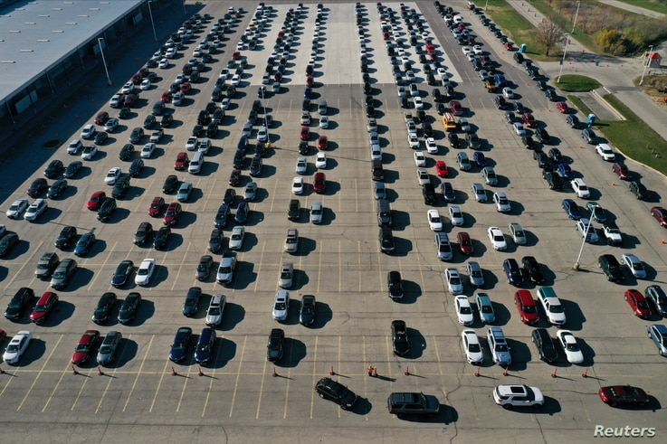 An aerial view of vehicles queuing at a drive-thru COVID-19 testing site in Madison, Wisconsin.