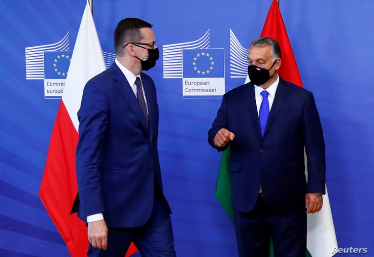 FILE PHOTO: Poland's Prime Minister Mateusz Morawiecki and Hungary's Prime Minister Viktor Orban arrive ahead of a meeting with…