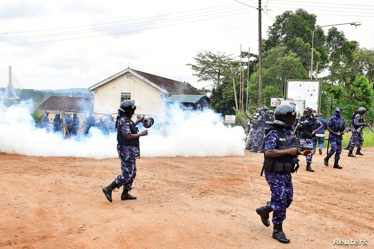 Ugandan riot policemen fire tear gas canisters to disperse supporters of presidential candidate Robert Kyagulanyi, also known…