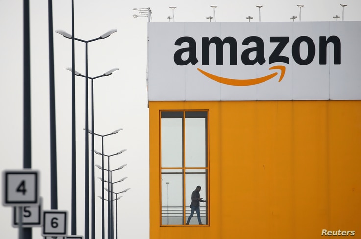 FILE PHOTO: The logo of Amazon is seen at the company logistics center in Lauwin-Planque, northern France, March 19, 2020…