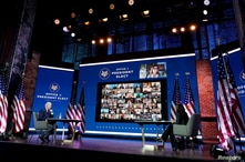 U.S. President-elect Joe Biden and Vice President-elect Kamala Harris listen during a videoconference meeting.