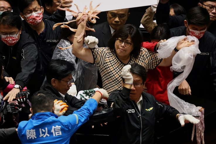 Taiwan lawmakers throw pork intestines at each other during a scuffle in the parliament in Taipei, Taiwan, November 27, 2020…