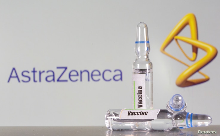 FILE PHOTO: A test tube labeled with the vaccine is seen in front of AstraZeneca logo in this illustration taken, September 9,…