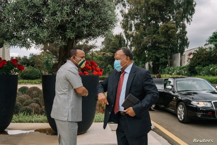 Ethiopian Prime Minister Abiy Ahmed greets an African Union (AU) envoy in Addis Ababa, Ethiopia November 27, 2020, in this…