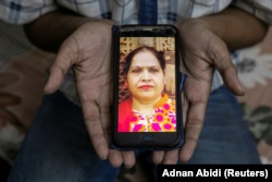 Fardeen Khan, 19, a student, shows a picture on his phone of his mother Noor Jahan, a housewife, who died due to the coronavirus disease (COVID-19), for a photograph, in New Delhi, India, September 27, 2020.