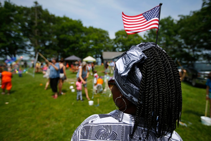 FILE - In this July 4, 2019, file photo, Malu Klo, an asylum seeker from the Congo, attends a picnic for refugees at Fort…