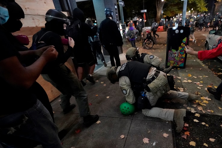 Oregon State Police arrest a protester in Portland, Ore., Wednesday, Nov. 4, 2020, following Tuesday's election. (AP Photo…
