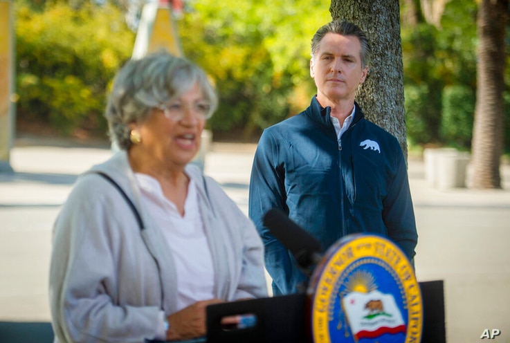 California Air Resources Board chair Mary Nichols, left, speaks as California Gov. Gavin Newsom listens at a press conference…