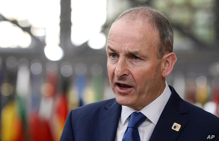 Ireland's Prime Minister Micheal Martin speaks with the media as he arrives for an EU summit in Brussels, Friday, Oct. 16, 2020…