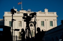 Journalists gather outside the White House, Wednesday, Nov. 4, 2020, in Washington. (AP Photo/Evan Vucci)