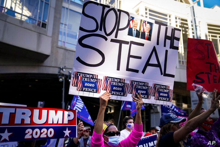 President Donald Trump supporters gather with some signs claiming a stolen election outside the Philadelphia Convention Center…