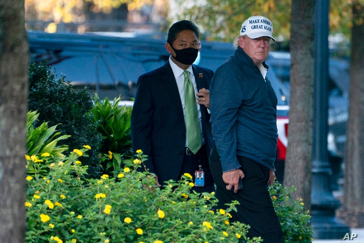 President Donald Trump returns to the White House after playing a round of golf, Saturday, Nov. 7, 2020, in Washington. (AP…