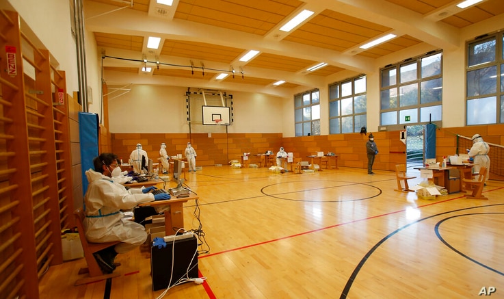 Medical staff members wait for citizens to be tested for coronavirus at a school gym that was set up as a testing facility in…