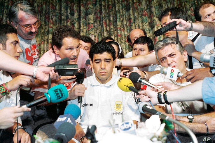 FILE - In this June 30, 1994 file photo Argentina World Cup soccer player Diego Maradona is the center of media attention at…