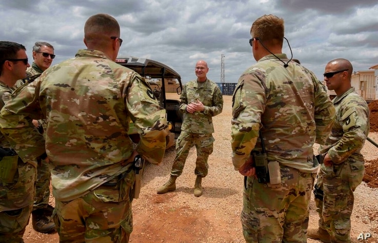U.S. Army Brig. Gen. Damian T. Donahoe, deputy commanding general, Combined Joint Task Force - Horn of Africa, center, talks…