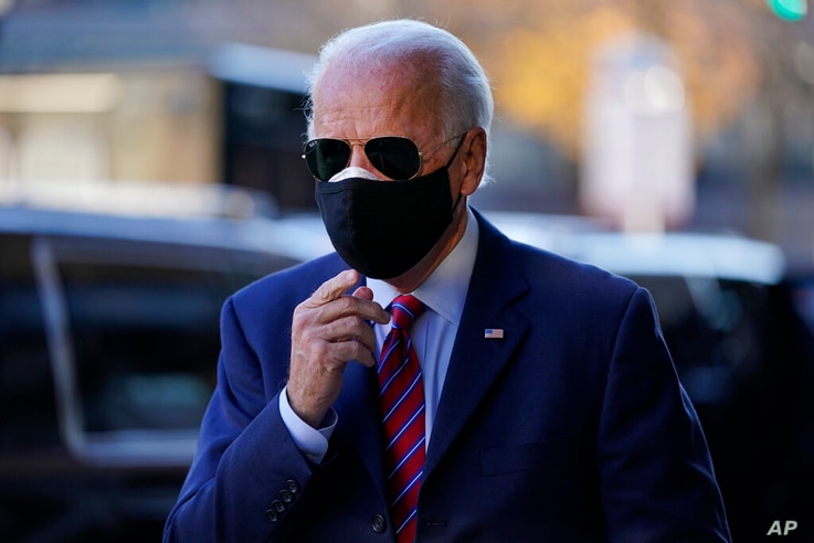 FILE - In this Nov. 23, 2020, file photo President-elect Joe Biden walks from his motorcade to speak to members of the media in…