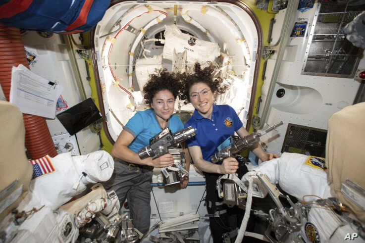 In this photo released by NASA on Thursday, Oct. 17, 2019, U.S. astronauts Jessica Meir, left, and Christina Koch pose for a…