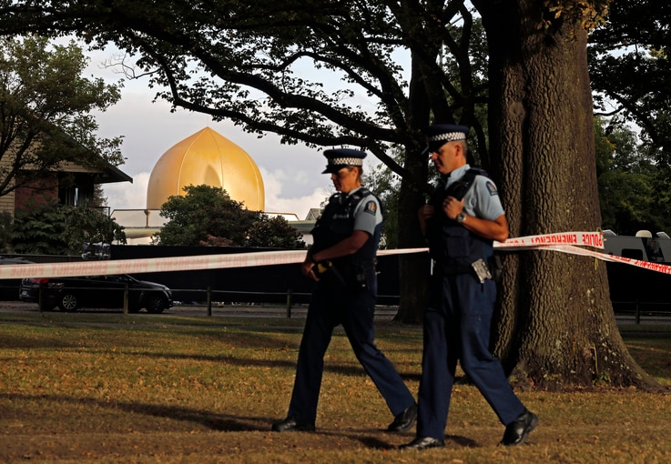 FILE - In this March 20, 2019, file photo, police officers patrol at a park outside the Al Noor mosque in Christchurch, New Zealand. 