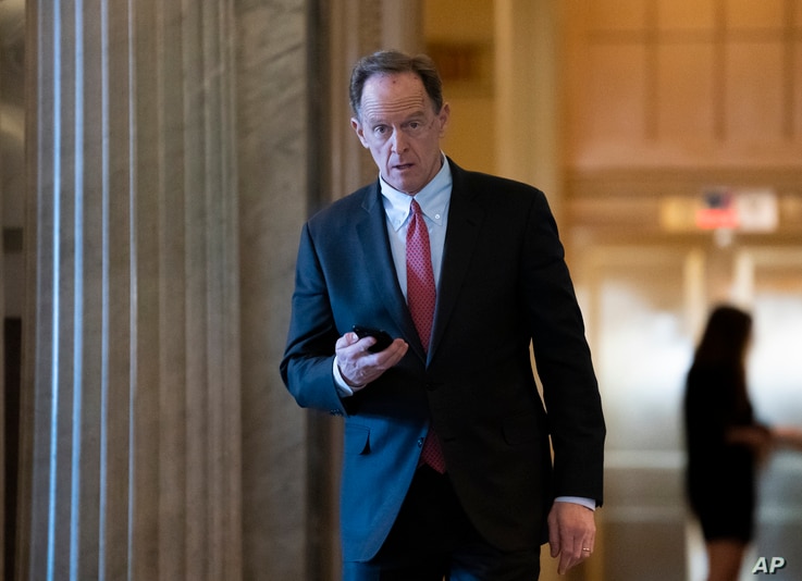 Sen. Pat Toomey, R-Pa., returns from a break in the impeachment trial of President Donald Trump on charges of abuse of power…