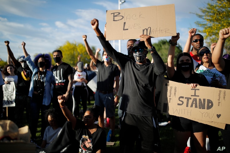 Protesters hold their fists in the air during a rally in Las Vegas against police brutality sparked by the death of George Floyd,June 5, 2020. 