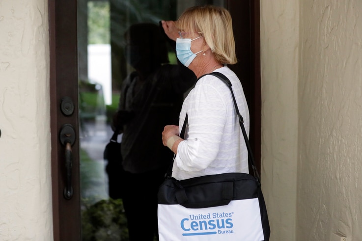 A census taker knocks on the door of a residence in Winter Park, Florida, Aug. 11, 2020.