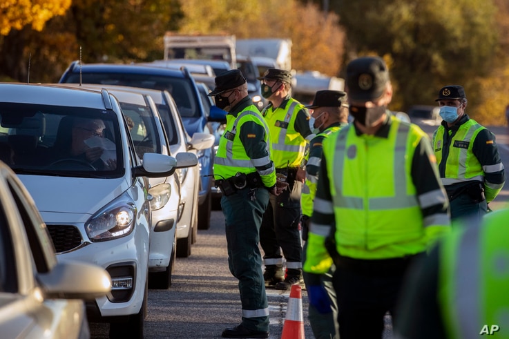 Guardia Civil officers stop vehicles at a checkpoint in Somosierra, Spain, Friday, Oct. 30, 2020. All Spanish regions except…