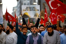 Protesters, some holding Turkish flags, chant slogans during a demonstration in Istanbul against the move of the U.S. embassy from Tel Aviv to Jerusalem, May 14, 2018. 