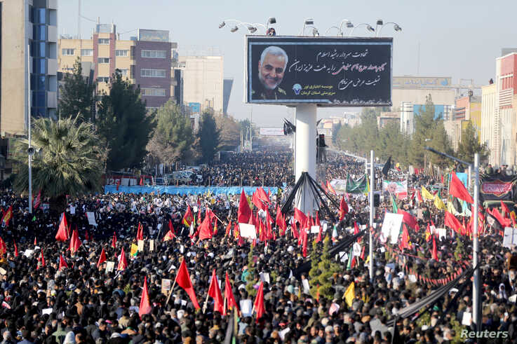 Iranian people attend a funeral procession and burial for Iranian Major-General Qassem Soleimani, head of the elite Quds Force,…