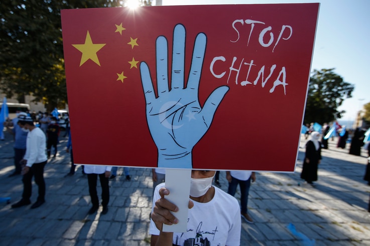 A protester from the Uighur community living in Turkey, holds an anti-China placard during a protest in Istanbul, Thursday, Oct…